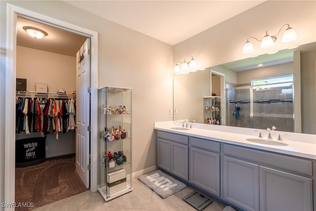 1410 SW 38th St, Cape Coral, FL 33914 - full bath with a stall shower, double vanity, tile patterned flooring, a walk in closet, and baseboards