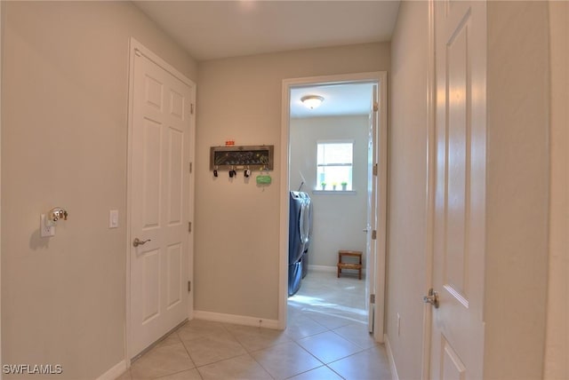 1410 SW 38th St, Cape Coral, FL 33914 - hall with washing machine and clothes dryer, light tile patterned flooring, and baseboards