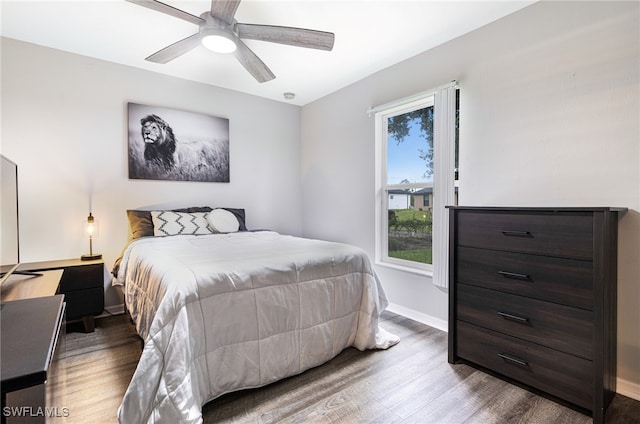 bedroom with baseboards, a ceiling fan, and wood finished floors