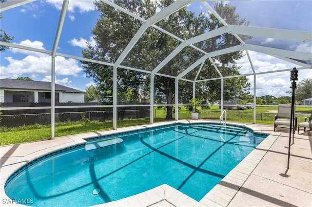 outdoor pool featuring fence, glass enclosure, and a patio area