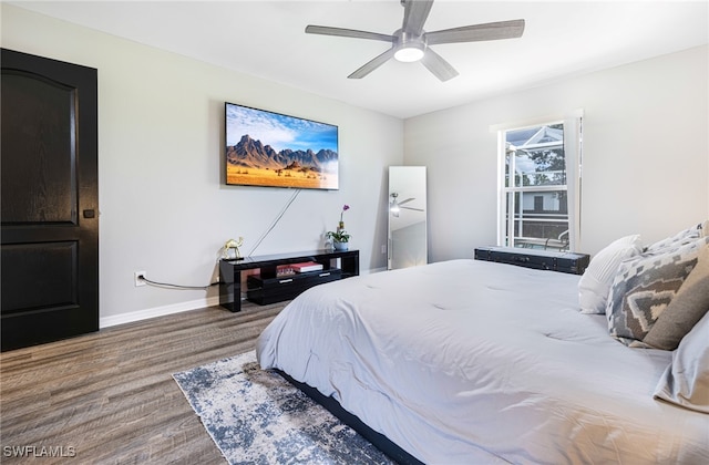 bedroom with baseboards, a ceiling fan, and wood finished floors