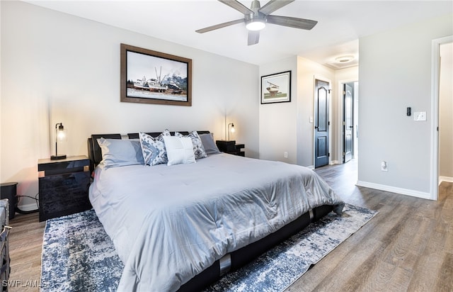 bedroom featuring baseboards, a ceiling fan, and wood finished floors