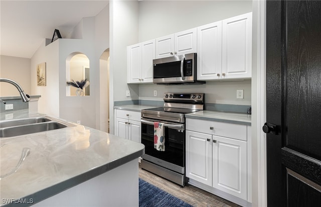 kitchen with white cabinets, stainless steel appliances, and a sink