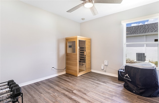 miscellaneous room with baseboards, ceiling fan, a wealth of natural light, and wood finished floors