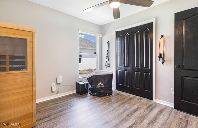 foyer entrance with baseboards, ceiling fan, and wood finished floors