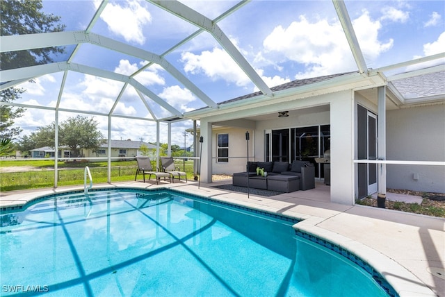 pool featuring glass enclosure, an outdoor living space, and a patio area
