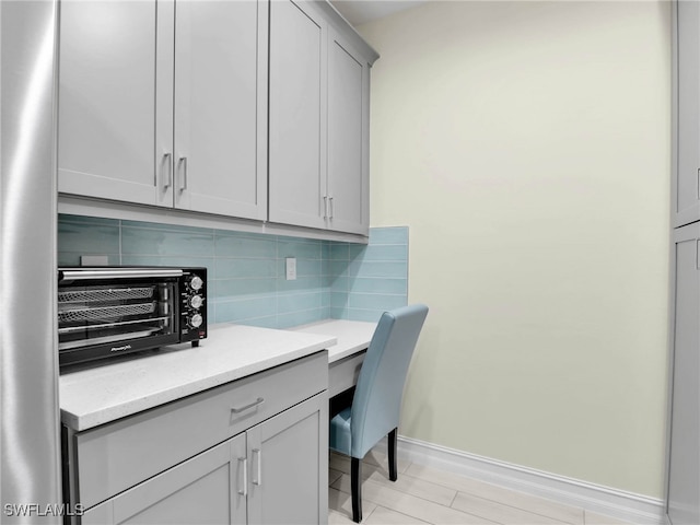 home office with a toaster and baseboards