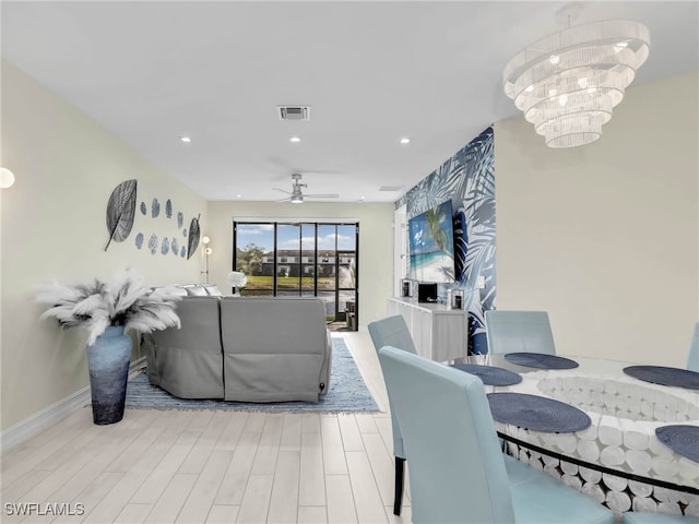 dining area featuring recessed lighting, wood finished floors, ceiling fan with notable chandelier, baseboards, and visible vents