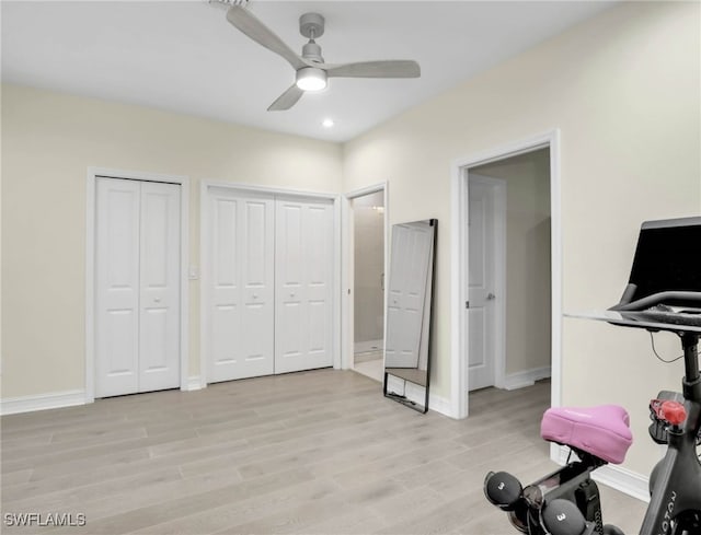 exercise room featuring baseboards, a ceiling fan, and light wood finished floors