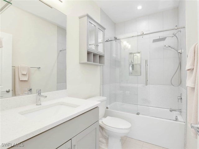 full bathroom featuring bath / shower combo with glass door, vanity, toilet, and tile patterned flooring