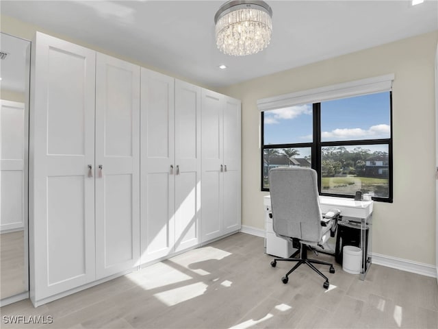 office area featuring light wood-type flooring, recessed lighting, a notable chandelier, and baseboards
