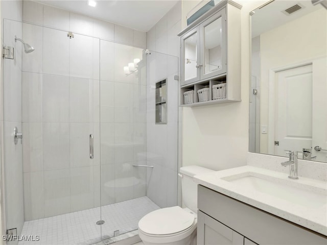 full bath featuring toilet, visible vents, a shower stall, and vanity