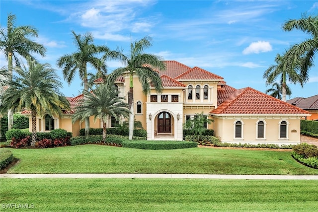 580 S Heathwood Dr, Marco Island, FL 34145 - mediterranean / spanish-style home with stucco siding, a tile roof, and a front yard