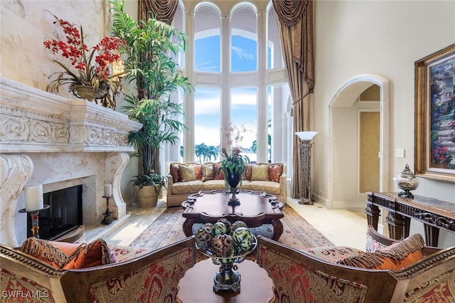 580 S Heathwood Dr, Marco Island, FL 34145 - living area featuring a high end fireplace, a towering ceiling, and arched walkways
