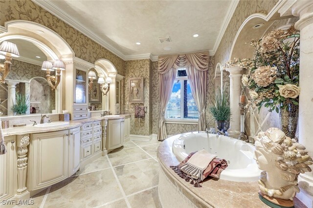 580 S Heathwood Dr, Marco Island, FL 34145 - bathroom with wallpapered walls, a whirlpool tub, crown molding, and ornate columns