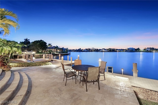 580 S Heathwood Dr, Marco Island, FL 34145 - patio terrace at dusk featuring a water view and a boat dock