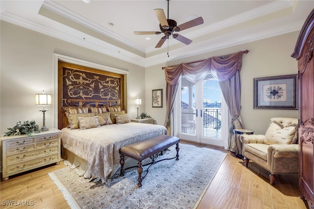580 S Heathwood Dr, Marco Island, FL 34145 - bedroom with ornamental molding, a tray ceiling, access to exterior, and light wood-type flooring