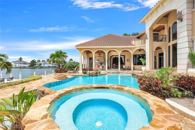 580 S Heathwood Dr, Marco Island, FL 34145 - view of swimming pool with a pool with connected hot tub, a water view, and a patio area
