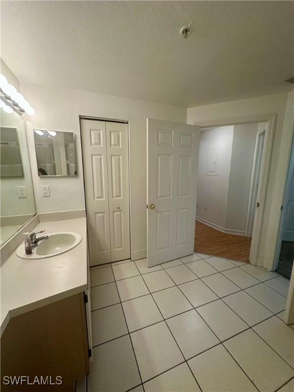 bathroom with tile patterned floors and vanity