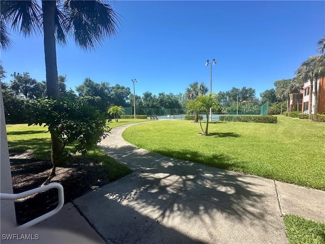 view of home's community featuring fence and a yard