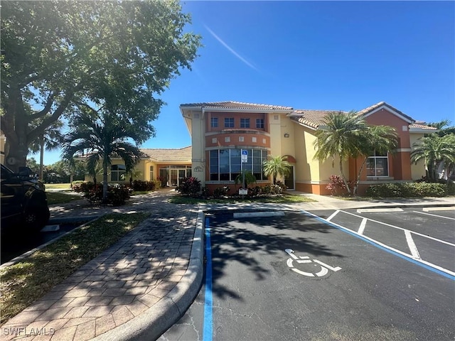 view of property featuring uncovered parking