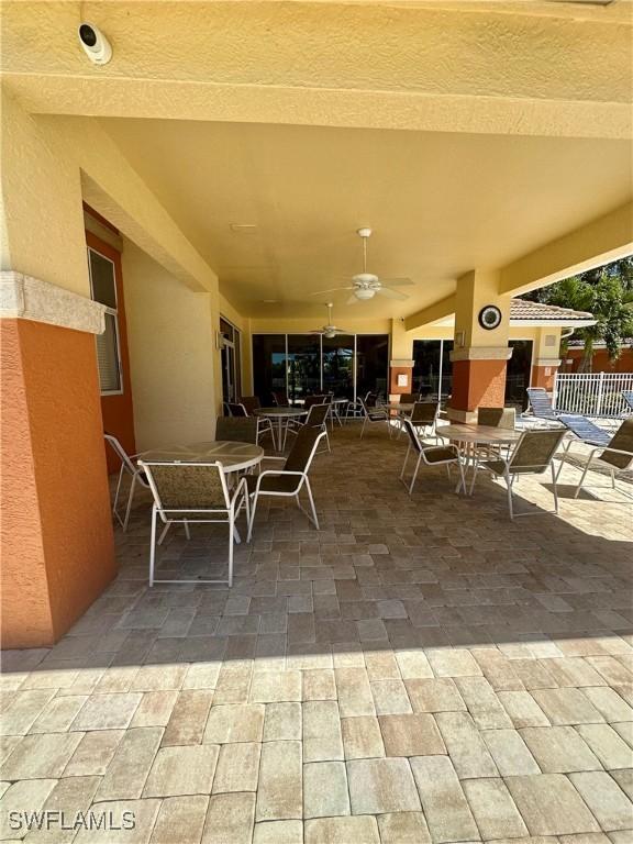 view of patio / terrace featuring ceiling fan, outdoor dining area, and fence