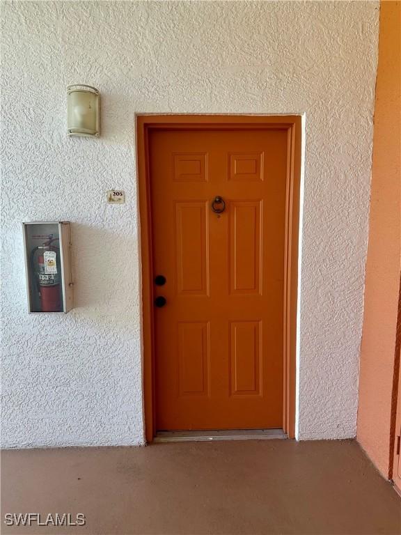 doorway to property with stucco siding