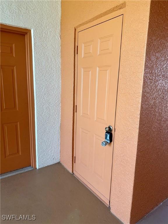 doorway to property featuring stucco siding