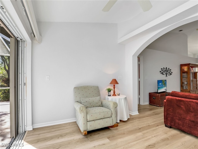5774 Greenwood Cir Unit 64, Naples, FL 34112 - living area with arched walkways, baseboards, ceiling fan, and wood finished floors