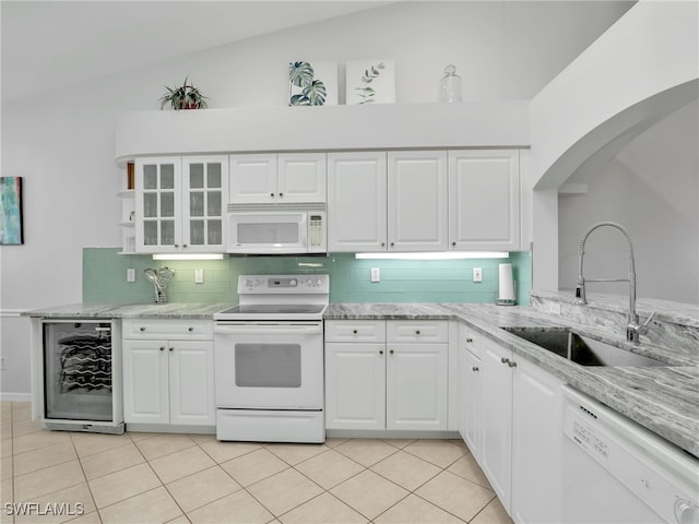 5774 Greenwood Cir Unit 64, Naples, FL 34112 - kitchen with wine cooler, backsplash, a sink, light tile patterned floors, and white appliances