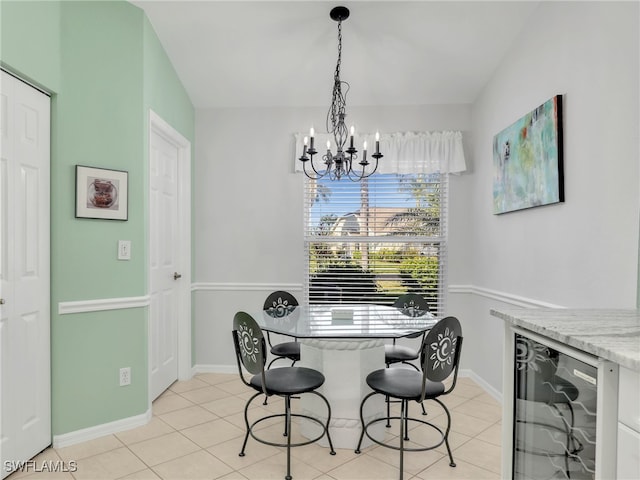 5774 Greenwood Cir Unit 64, Naples, FL 34112 - dining room with light tile patterned flooring, baseboards, wine cooler, and a chandelier