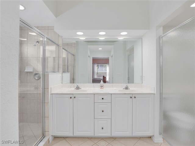 5774 Greenwood Cir Unit 64, Naples, FL 34112 - bathroom with a shower stall, double vanity, and a sink
