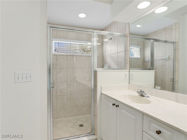 5774 Greenwood Cir Unit 64, Naples, FL 34112 - bathroom featuring vanity, recessed lighting, and a shower stall