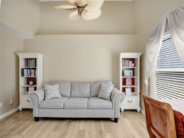 5774 Greenwood Cir Unit 64, Naples, FL 34112 - living area featuring light wood finished floors, baseboards, a high ceiling, and a ceiling fan