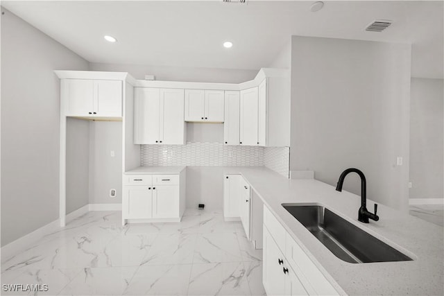 1034 Green Field St, Lehigh Acres, FL 33974 - kitchen featuring a sink, light marble finish flooring, baseboards, and recessed lighting