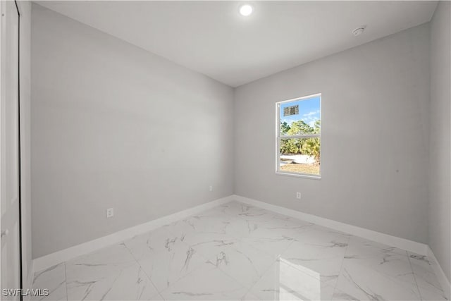 1034 Green Field St, Lehigh Acres, FL 33974 - empty room with baseboards, light marble finish floors, and recessed lighting