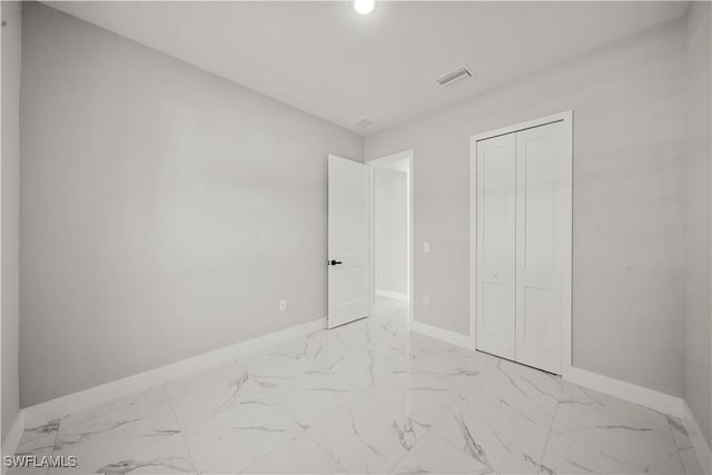 1034 Green Field St, Lehigh Acres, FL 33974 - unfurnished bedroom with baseboards, light marble finish flooring, a closet, and recessed lighting
