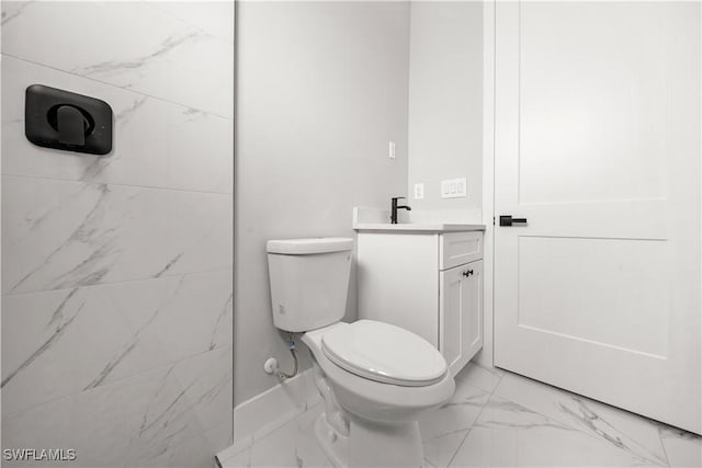 1034 Green Field St, Lehigh Acres, FL 33974 - bathroom with marble look tiles, toilet, and vanity