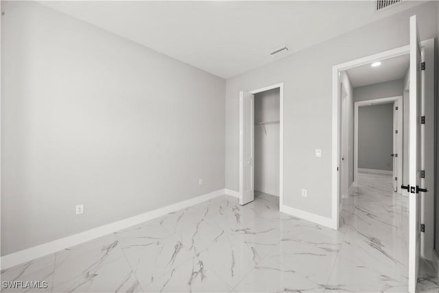 1034 Green Field St, Lehigh Acres, FL 33974 - unfurnished bedroom featuring light marble finish floors, baseboards, and a closet