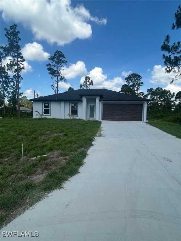 1034 Green Field St, Lehigh Acres, FL 33974 - single story home featuring an attached garage, concrete driveway, and stucco siding