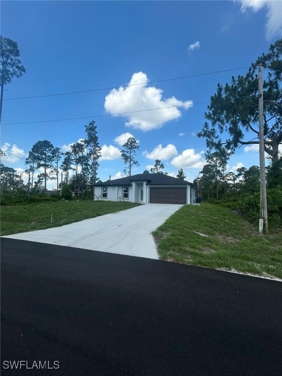 1034 Green Field St, Lehigh Acres, FL 33974 - single story home featuring an attached garage, concrete driveway, and a front lawn