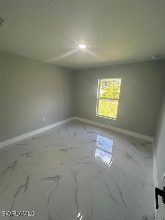 1034 Green Field St, Lehigh Acres, FL 33974 - empty room with baseboards, recessed lighting, and marble finish flooring