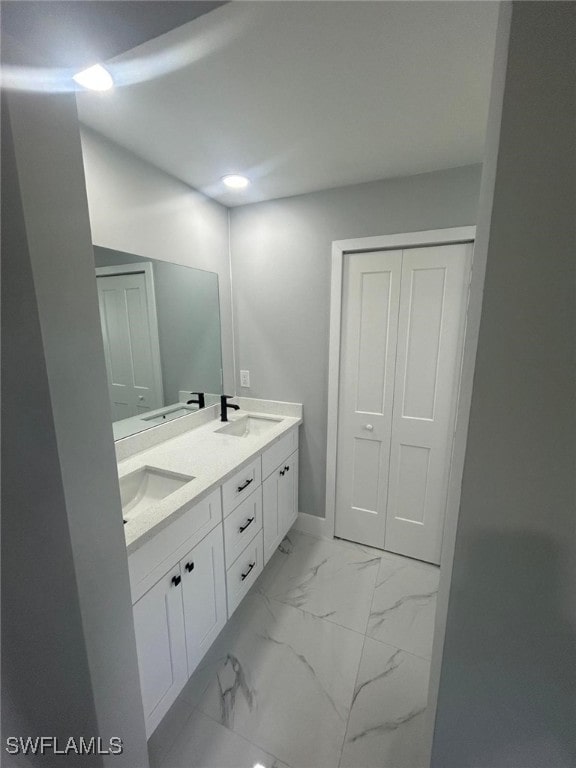 1034 Green Field St, Lehigh Acres, FL 33974 - full bath with double vanity, marble look tiles, baseboards, and recessed lighting