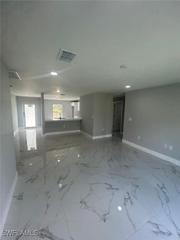1034 Green Field St, Lehigh Acres, FL 33974 - unfurnished room featuring baseboards, recessed lighting, and light marble finish flooring