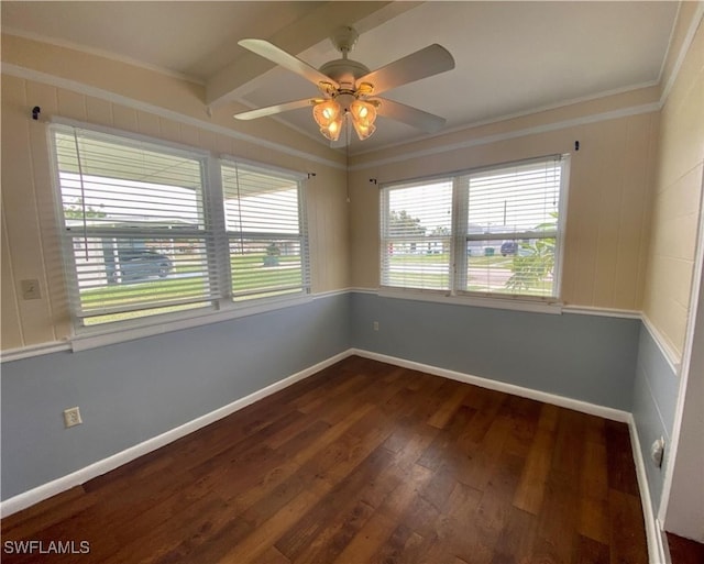 empty room featuring baseboards, dark wood-style floors, a ceiling fan, and ornamental molding