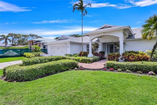 750 Southern Pines Dr, Naples, FL 34103 - ranch-style house with a garage, a front yard, and stucco siding