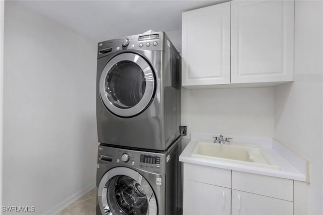 750 Southern Pines Dr, Naples, FL 34103 - laundry room with stacked washer and clothes dryer, cabinet space, and tile patterned floors