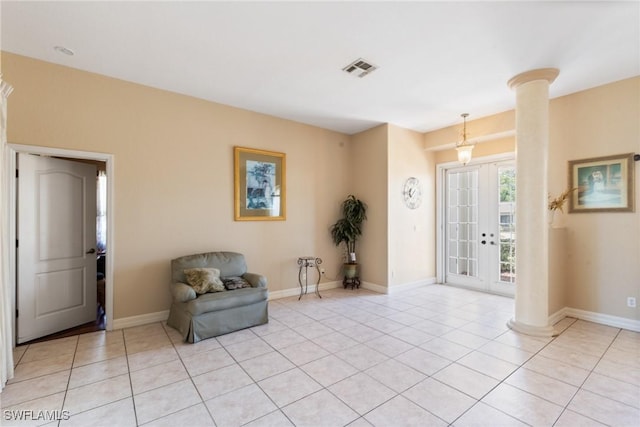 foyer with visible vents, decorative columns, light tile patterned floors, and french doors