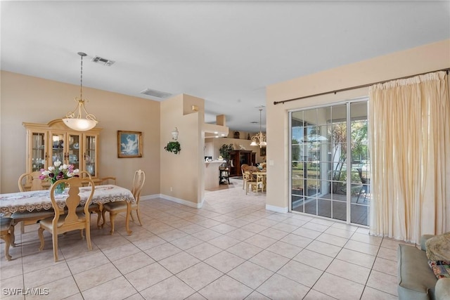 dining space with light tile patterned floors, baseboards, and visible vents