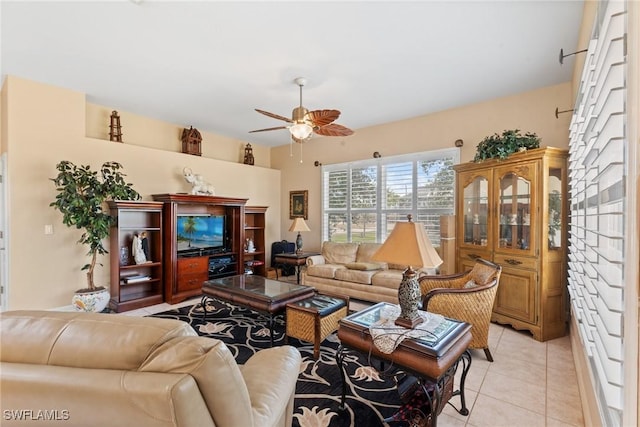 living room with a ceiling fan and light tile patterned flooring